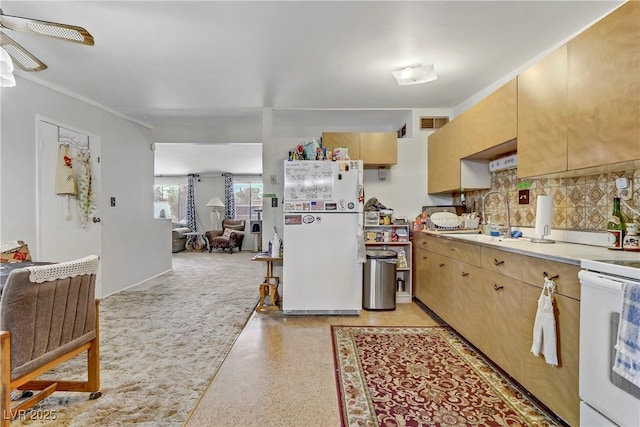 kitchen featuring visible vents, decorative backsplash, white appliances, light countertops, and a sink