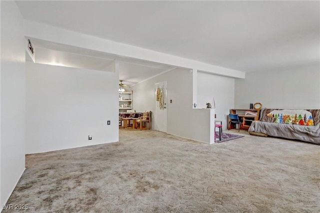 living area featuring carpet floors and a ceiling fan