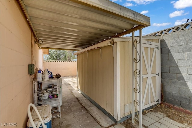 exterior space with an outdoor structure, fence, and a shed