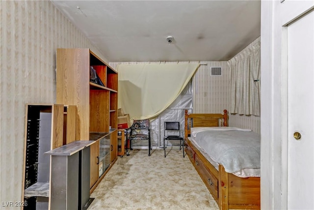 carpeted bedroom with wallpapered walls and visible vents