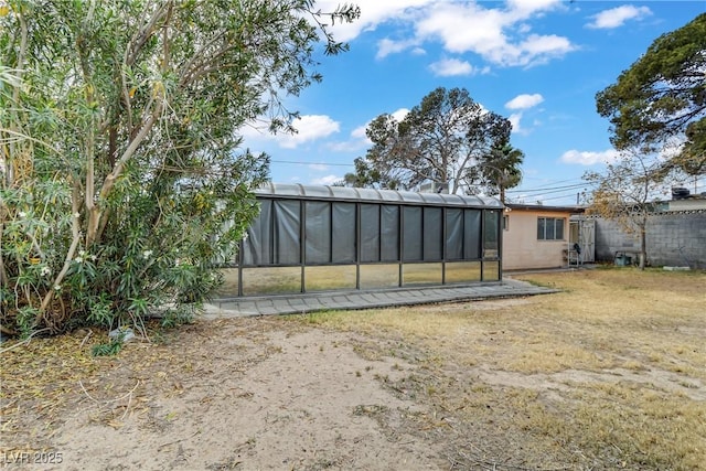 rear view of property with a fenced backyard and a lawn