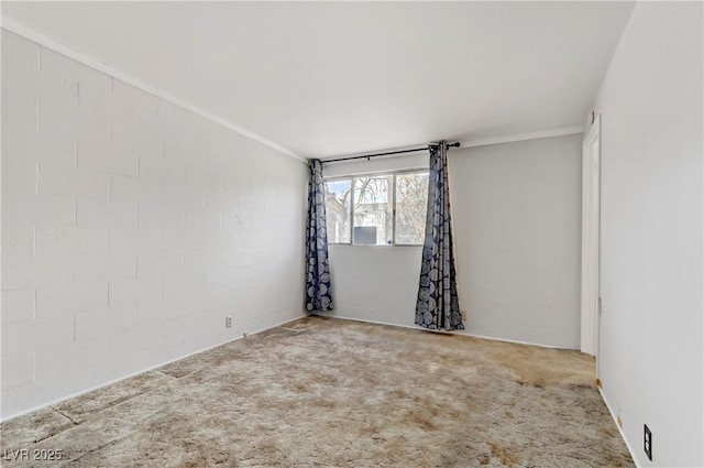 carpeted spare room with crown molding