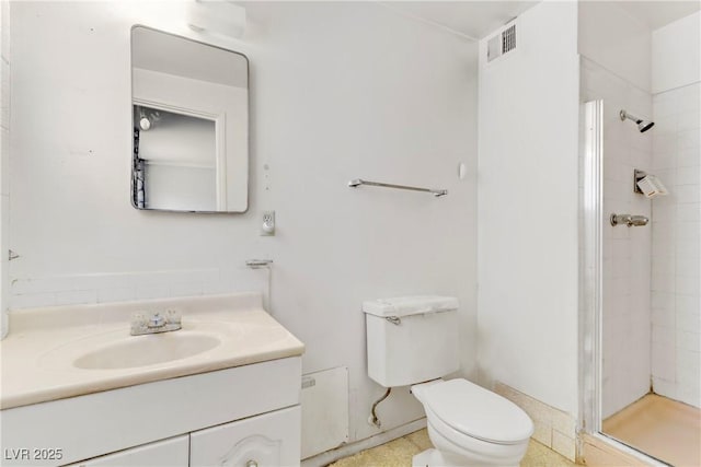 bathroom with toilet, visible vents, a shower stall, and vanity