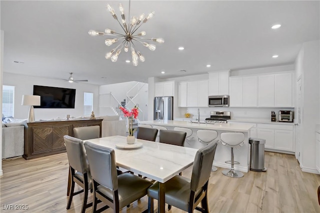 4436 Mural Glen Ct, North Las Vegas, NV 89084 - dining area with recessed lighting, light wood finished floors, ceiling fan with notable chandelier, and a wealth of natural light