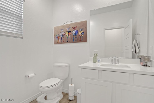 4436 Mural Glen Ct, North Las Vegas, NV 89084 - bathroom featuring vanity, baseboards, wood finished floors, and toilet