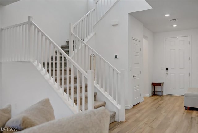 4436 Mural Glen Ct, North Las Vegas, NV 89084 - staircase featuring recessed lighting, visible vents, and wood finished floors