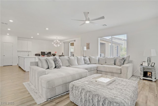 4436 Mural Glen Ct, North Las Vegas, NV 89084 - living area featuring recessed lighting, visible vents, ceiling fan with notable chandelier, and light wood-style floors