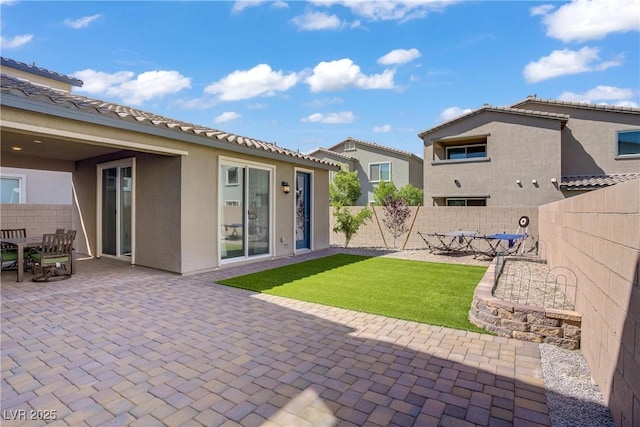4436 Mural Glen Ct, North Las Vegas, NV 89084 - rear view of house with a patio, a fenced backyard, stucco siding, a tiled roof, and a lawn