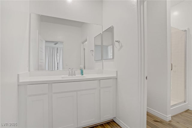 4436 Mural Glen Ct, North Las Vegas, NV 89084 - bathroom featuring vanity, baseboards, wood finished floors, and a shower stall
