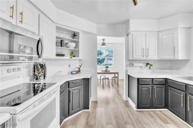 kitchen with stainless steel microwave, white cabinets, ceiling fan, light wood-type flooring, and white range with electric stovetop