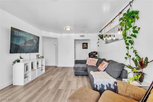 living room with light wood-type flooring and baseboards