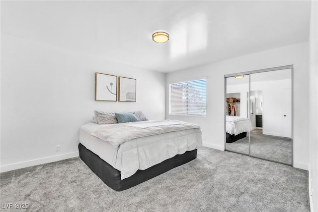carpeted bedroom featuring a closet and baseboards