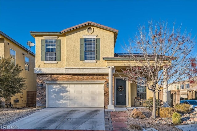 traditional-style home with an attached garage, driveway, and stucco siding