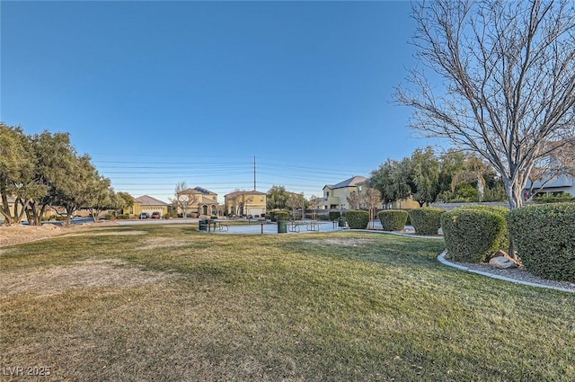 surrounding community featuring a lawn and a residential view