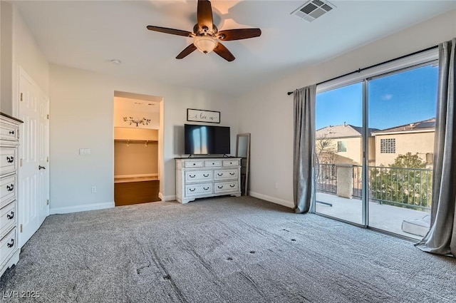interior space with visible vents, baseboards, ceiling fan, access to outside, and carpet flooring