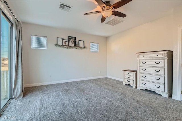 unfurnished bedroom with baseboards, ceiling fan, carpet, and visible vents
