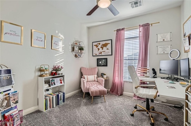 carpeted office featuring baseboards, a ceiling fan, and visible vents