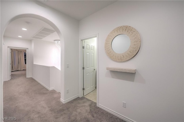 hall with visible vents, arched walkways, baseboards, carpet flooring, and recessed lighting