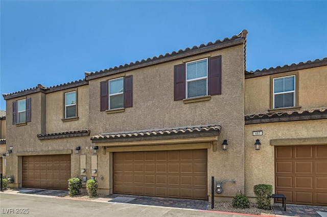 489 Filaree Pl, Henderson, NV 89015 - townhome / multi-family property with an attached garage, stucco siding, and a tile roof