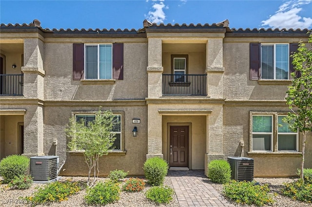 489 Filaree Pl, Henderson, NV 89015 - view of front facade with central AC unit, stucco siding, and a balcony