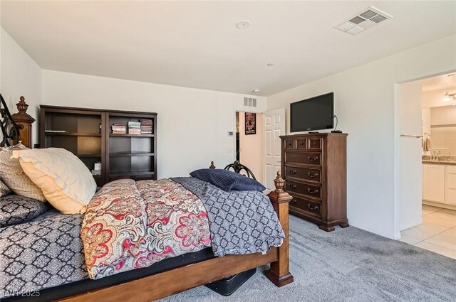 489 Filaree Pl, Henderson, NV 89015 - bedroom featuring connected bathroom, baseboards, visible vents, and light carpet