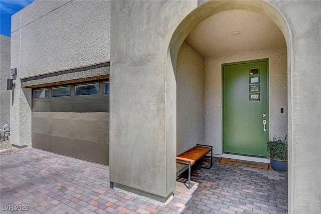 view of exterior entry with stucco siding