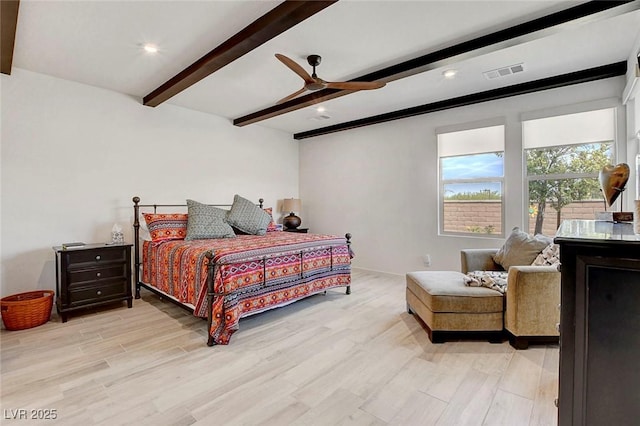 bedroom featuring ceiling fan, beamed ceiling, light wood-style flooring, and visible vents