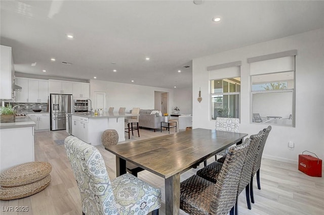 dining space featuring light wood-type flooring and recessed lighting