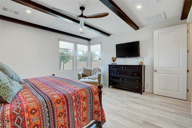 bedroom featuring visible vents, beam ceiling, and light wood-type flooring
