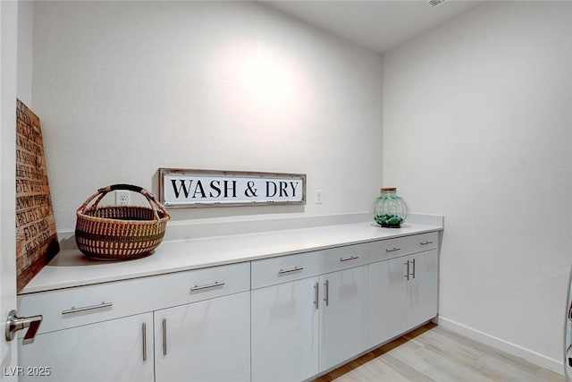 room details featuring baseboards and wood finished floors