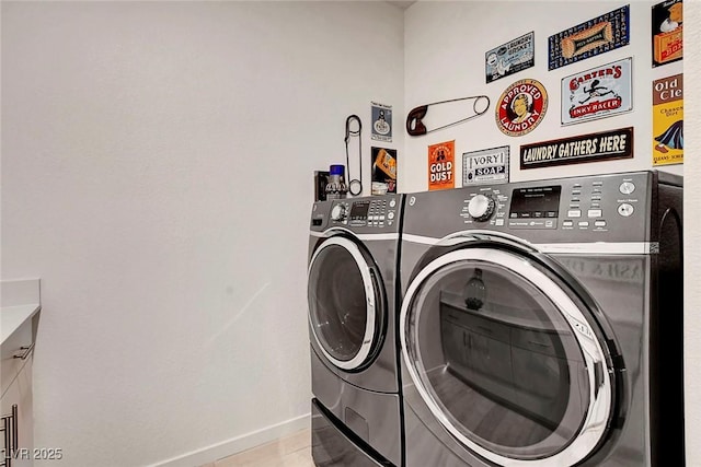 laundry area with baseboards, laundry area, and washer and dryer