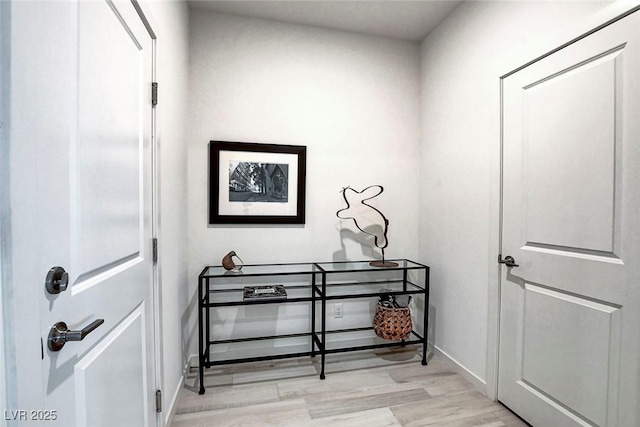 interior space featuring baseboards and light wood-style floors