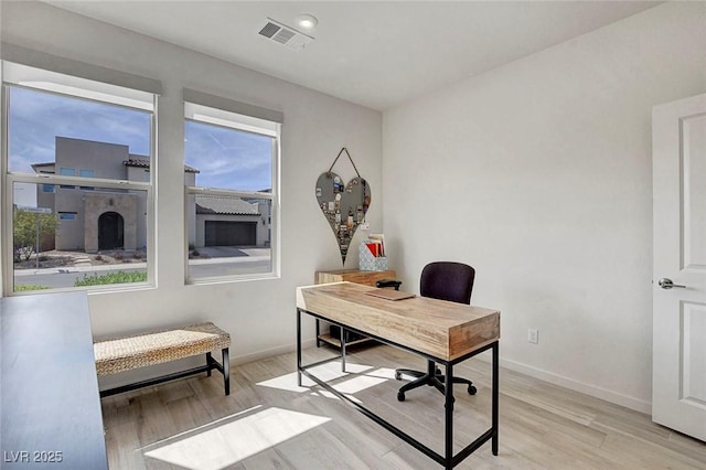 office area featuring baseboards, wood finished floors, and visible vents