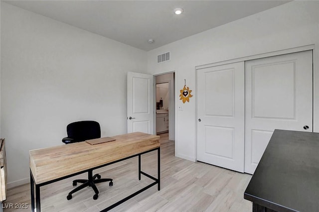 office area with recessed lighting, baseboards, light wood-type flooring, and visible vents