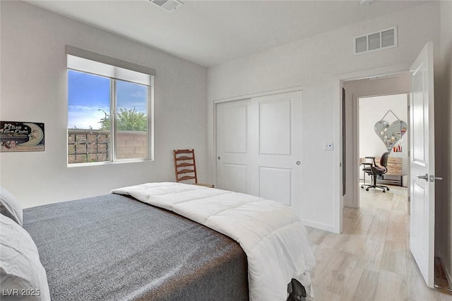 bedroom with a closet and visible vents