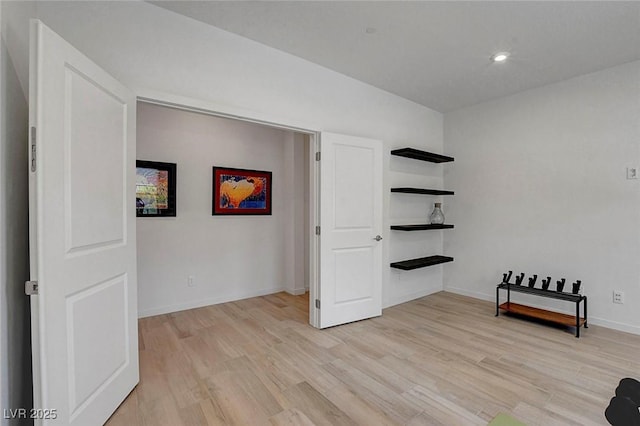 interior space featuring baseboards, recessed lighting, and light wood-style flooring