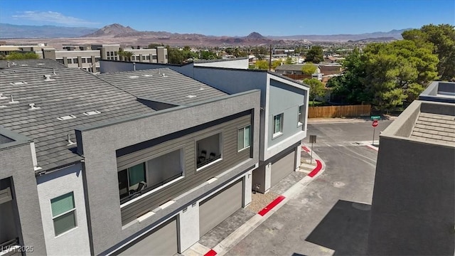 143 Aqua Commons Ln, Henderson, NV 89015 - view of side of home with a mountain view and fence
