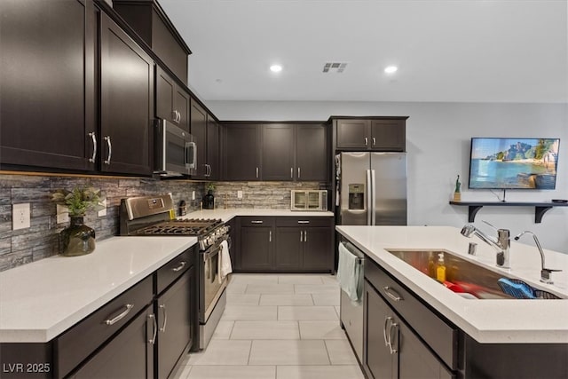 143 Aqua Commons Ln, Henderson, NV 89015 - kitchen featuring stainless steel appliances, a sink, decorative backsplash, light countertops, and recessed lighting