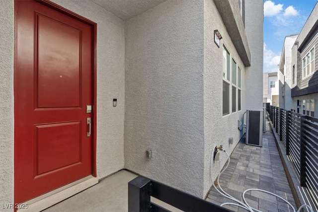143 Aqua Commons Ln, Henderson, NV 89015 - entrance to property featuring stucco siding, a balcony, and central air condition unit