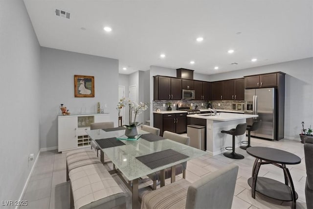 143 Aqua Commons Ln, Henderson, NV 89015 - dining space with light tile patterned floors, recessed lighting, and baseboards
