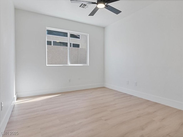 empty room featuring baseboards, ceiling fan, wood finished floors, and visible vents