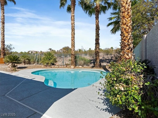 view of swimming pool featuring fence, a fenced in pool, and a patio area