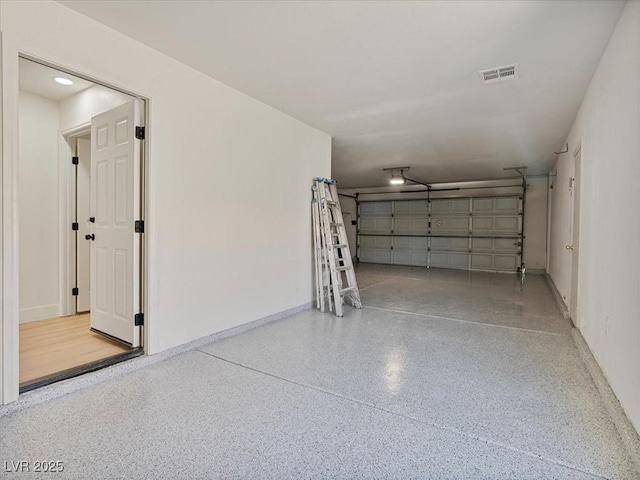 garage with baseboards and visible vents