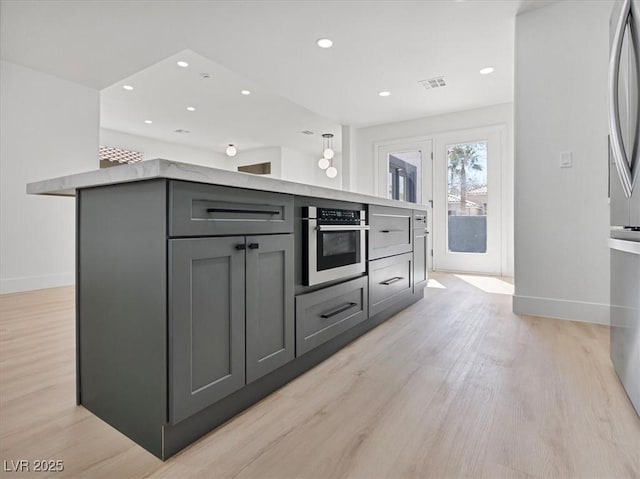 kitchen featuring visible vents, baseboards, light wood finished floors, recessed lighting, and oven
