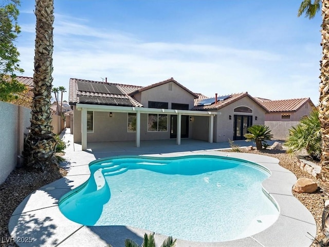view of swimming pool featuring a fenced in pool, french doors, a fenced backyard, and a patio area