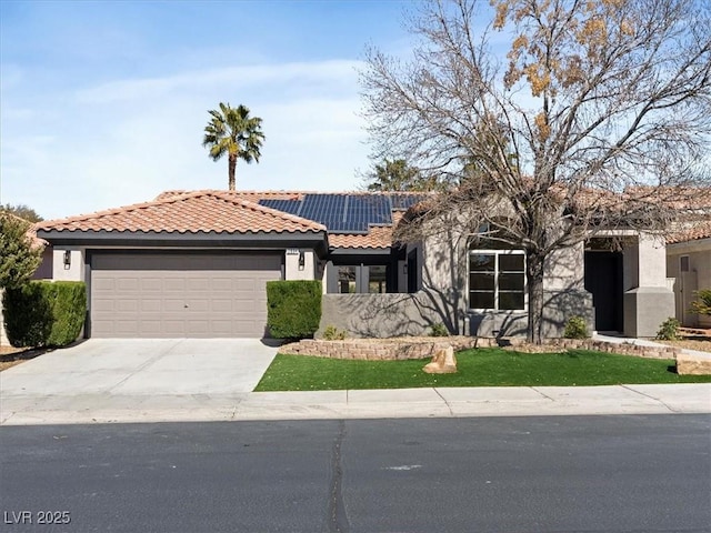 view of front facade with an attached garage, a tile roof, stucco siding, solar panels, and driveway