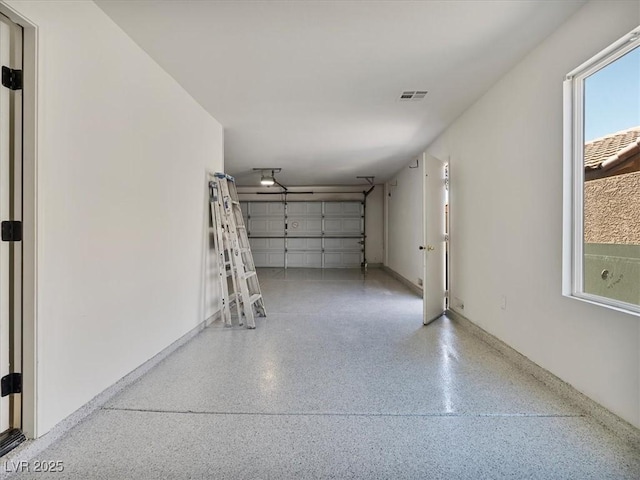 garage with visible vents and baseboards