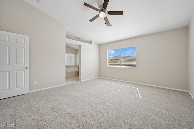 unfurnished bedroom with carpet floors, baseboards, a ceiling fan, and connected bathroom