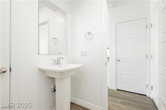 bathroom featuring baseboards and wood finished floors