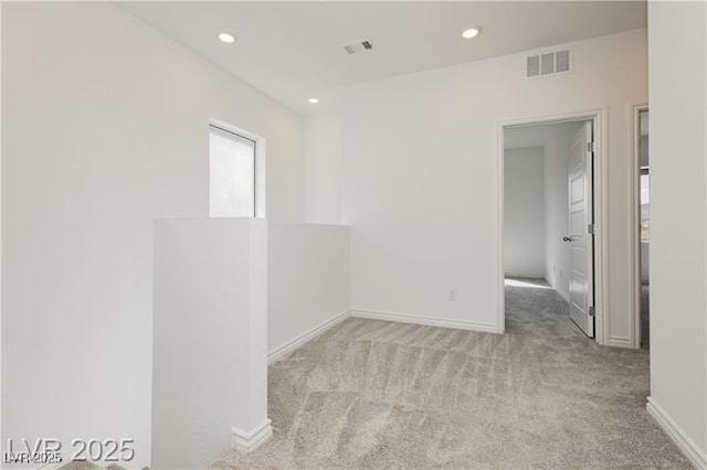 carpeted spare room with visible vents, recessed lighting, and baseboards